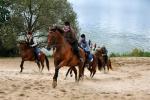 Riders, on horses, walking on a sandy beach, photo by J. Koniecko