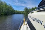 Photo shows white boat on the water.